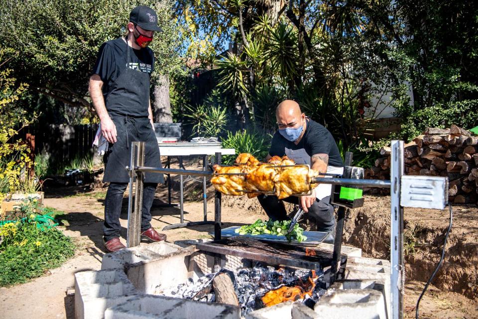 Chef Maynard Llera works the outside grill at his backyard pop-up