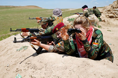 Iraqi Kurdish female fighter Haseba Nauzad (2nd R), 24, and Yazidi female fighter Asema Dahir (3rd R), 21, aim their weapon during a deployment near the frontline of the fight against Islamic State militants in Nawaran near Mosul, Iraq, April 20, 2016. REUTERS/Ahmed Jadallah