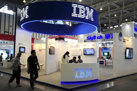 Visitors walk past the IBM booth at the 9th China International Software Product & Information Service Expo in Nanjing, Jiangsu province September 6, 2013. REUTERS/China Daily