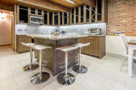 <p>The kitchen is chic and striking. It sits under the upper level of the loft.<br>(Airbnb) </p>