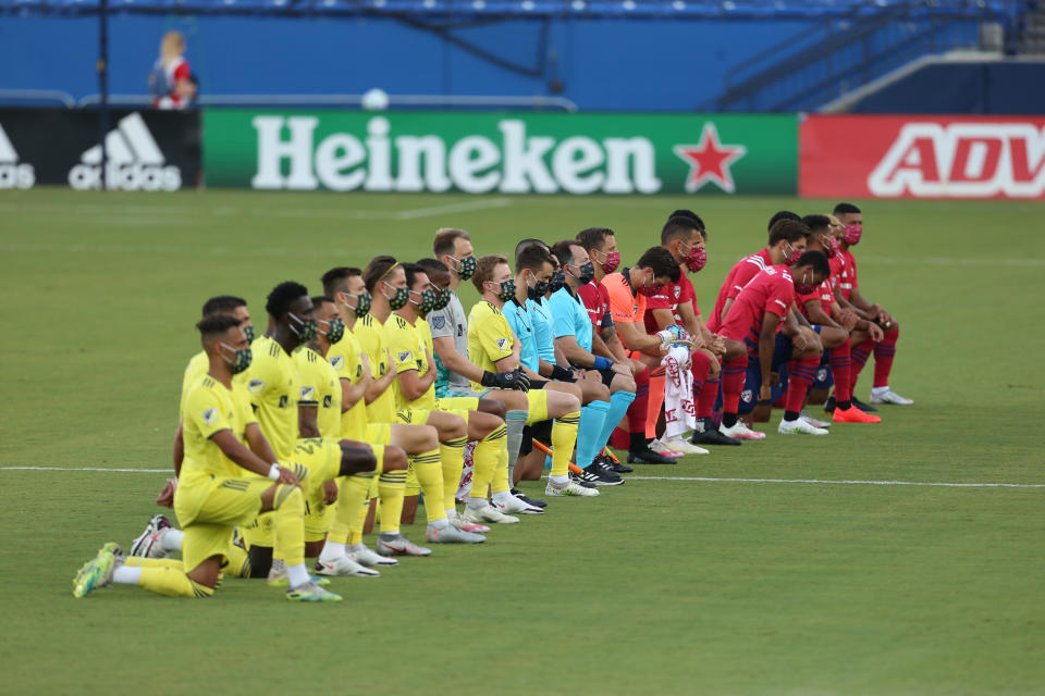 FC Dallas and Nashville SC players kneel before a game during the playing of the national anthem.