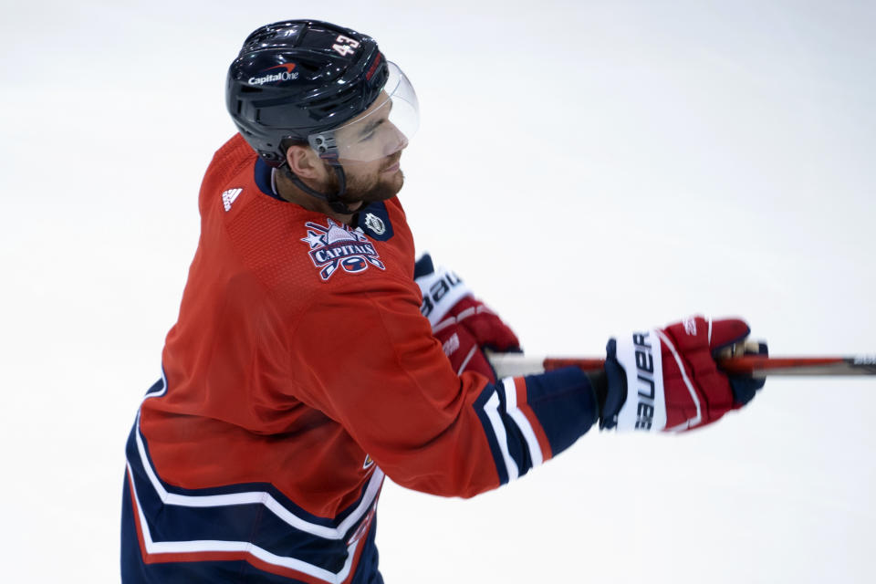 In this image provided by the Washington Capitals, Washington Capitals forward Tom Wilson wears a helmet bearing a Capital One logo during NHL hockey practice, Monday, Dec. 21, 2020, in Arlington, Va. (Zach Guerette/Washington Capitals via AP)