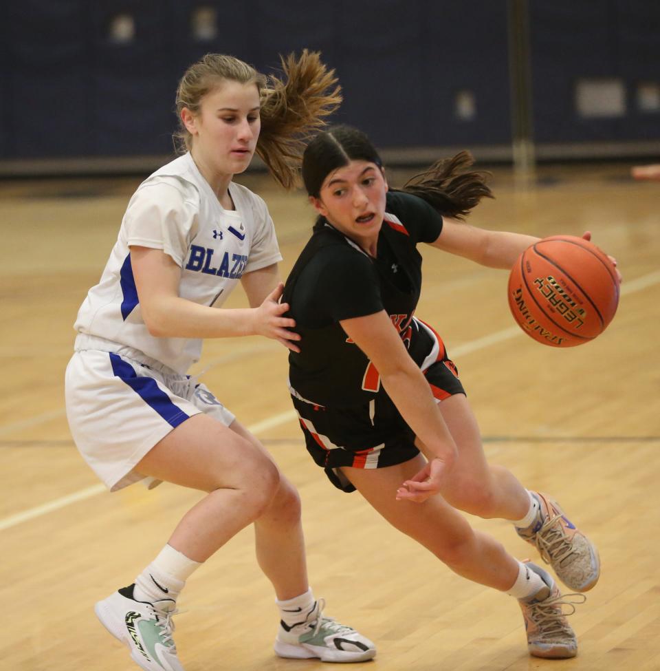 Tuckahoe's Juliana Manginelli drives around Millbrook's Lilly Kozera during the New York State Class C regional final on March 7, 2024.