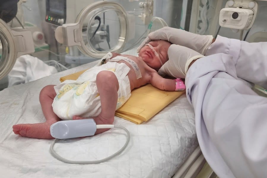 FILE – A Palestinian baby girl, Sabreen Jouda, who was delivered prematurely after her mother was killed in an Israeli strike along with her husband and daughter, lies in an incubator in the Emirati hospital in Rafah, southern Gaza Strip. Sunday, April 21, 2024. A premature Palestinian infant, rescued from her mother’s womb shortly after the woman was killed in an Israeli airstrike, has died, her uncle said Friday, April 26, 2024. (AP Photo/Mohammad Jahjouh, File)