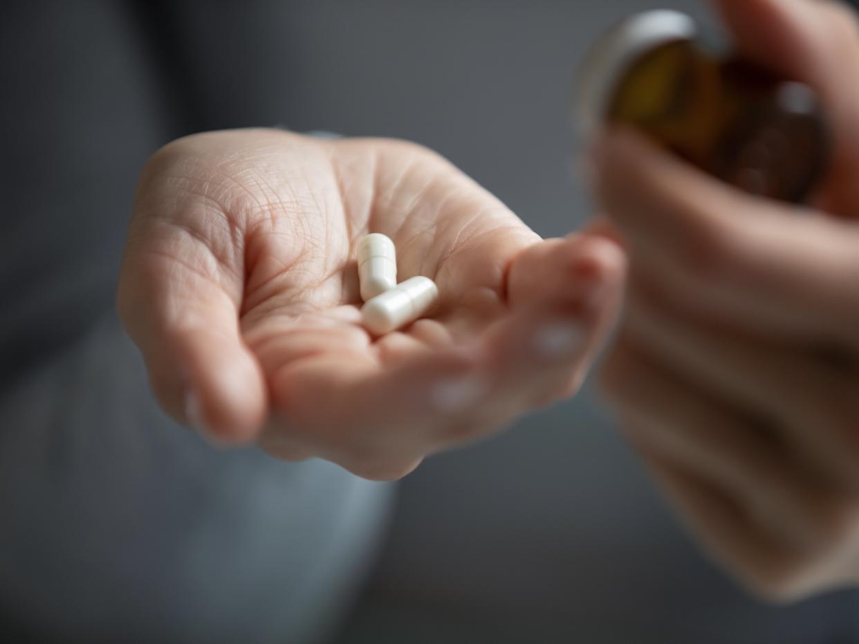 A person holds antidepressants (Shutterstock / fizkes)