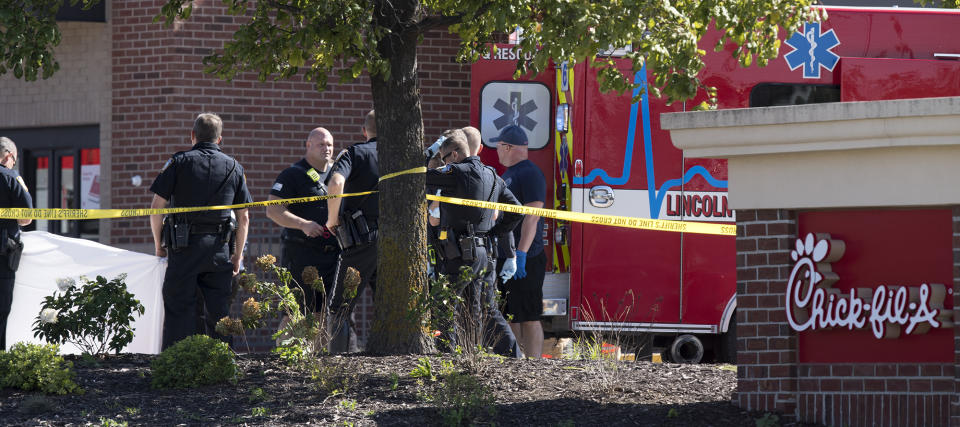 Lincoln Police Department investigates the scene of a shooting at a Chick-fil-A restaurant Tuesday, Oct. 8, 2019 in Lincoln, Neb. A uniformed railroad officer fatally shot a disgruntled customer who rammed his truck into restaurant police said Tuesday. 9Gwyneth Roberts/Lincoln Journal Star via AP)