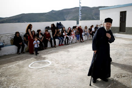 Friends and relatives attend the baptism of the first baby born on the islet of Thymaina after six years, with the financial support of the Aegean Team doctors, on the islet of Ayios Minas, Greece, May 12, 2017. REUTERS/Alkis Konstantinidis