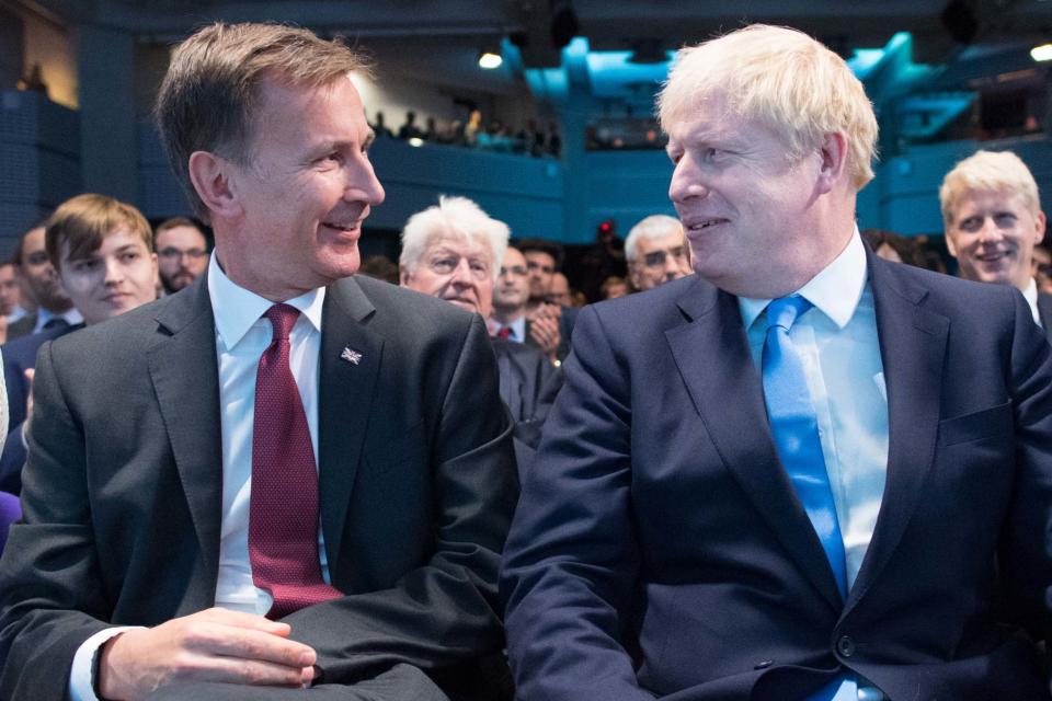 Jeremy Hunt and Boris Johnson, pictured together as Mr Johnson was announced the new Conservative party leader (EPA)