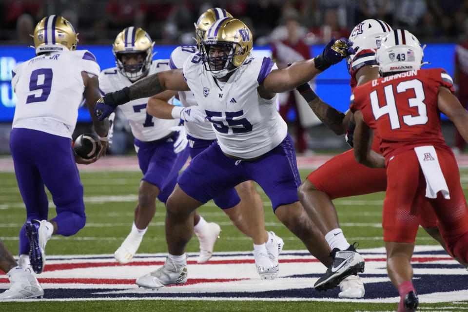 FILE - Washington offensive lineman Troy Fautanu (55) looks to block during the team's NCAA college football game against Arizona, Sept. 30, 2023, in Tucson, Ariz. For the final time in its current arrangement, the Morris Trophy winners were honored Thursday, Jan. 18, 2024 — the end to another small chapter of the Pac-12 legacy that crumbled under the weight of conference realignment. The honorees were Fautanu and UCLA defensive lineman Laiatu Latu. (AP Photo/Rick Scuteri, File)