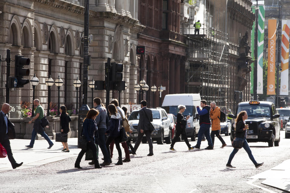 GLASGOW, SCOTLAND, GREAT BRITAIN - AUGUST 13: Commuters cross a downtown street during rush hour, on August 13, 2014 in Glasgow, Scotland, Great Britain. Scotland's economy is better than England's, which could be a factor during the Scottish referendum coming up in September when the Scots vote on whether to become independent. (Photo by Melanie Stetson Freeman/The Christian Science Monitor via Getty Images)