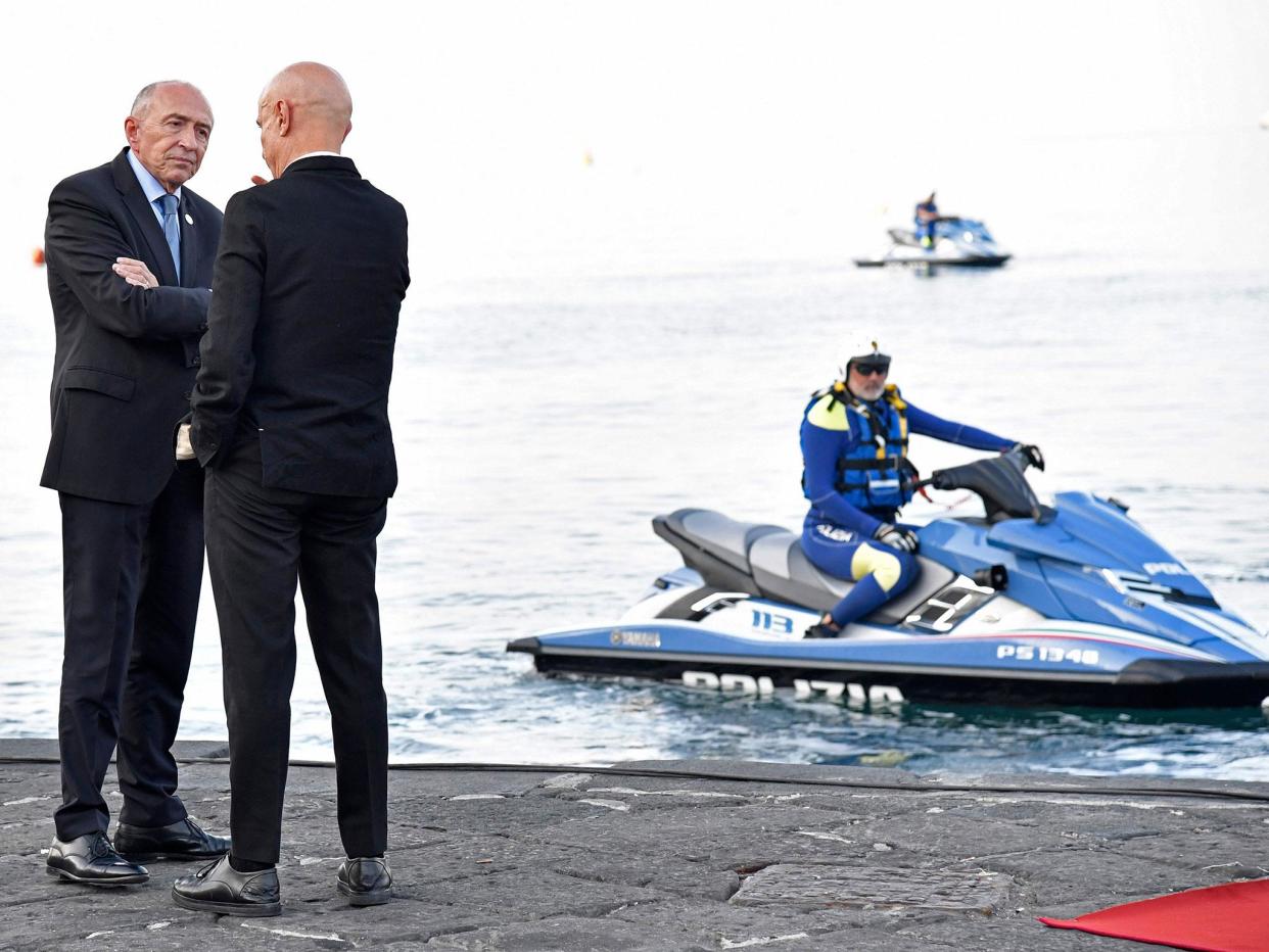 Police look on as Italy’s interior minister Marco Minniti welcomes France’s interior minister Gerard Collomb (L) to the summit: AFP