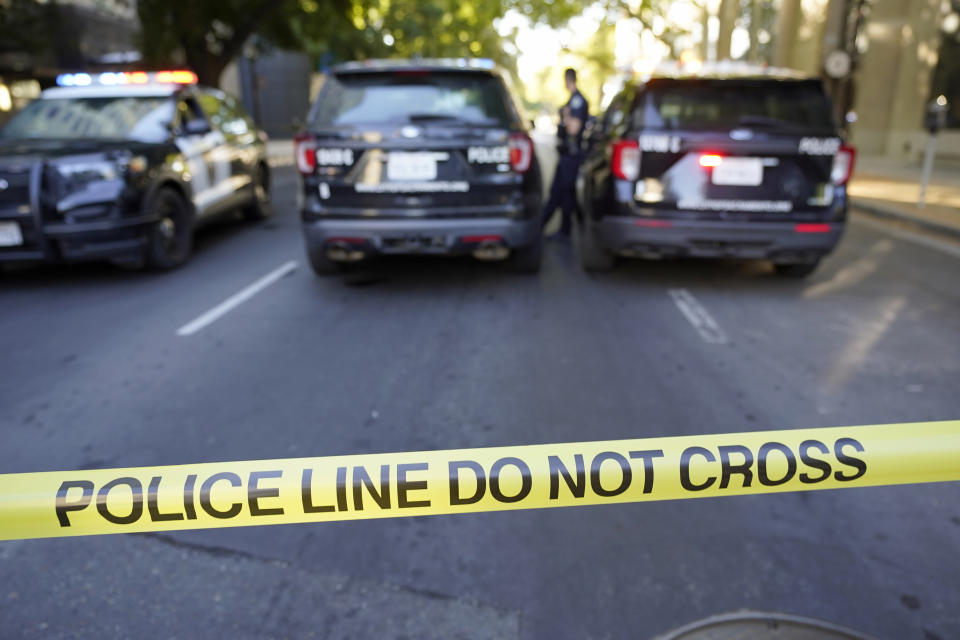 A police barricade blocks the street near the scene of a fatal shooting that also injured others outside of a downtown in Sacramento, Calif., night club in the early morning hours on Monday, July 4, 2022. (AP Photo/Rich Pedroncelli)