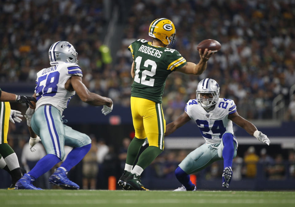 Green Bay Packers quarterback Aaron Rodgers (12) throws a pass as Dallas Cowboys defensive end Robert Quinn (58) and Chidobe Awuzie (24) defend in the first half of an NFL football game in Arlington, Texas, Sunday, Oct. 6, 2019. (AP Photo/Ron Jenkins)