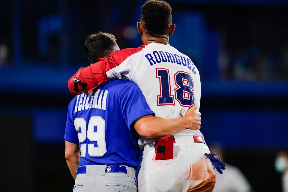 Israel's Alon Leichman and the Dominican Republic's Julio Rodriguez embrace after a baseball game at the 2020 Summer Olympics. Leichman was one of the only native Israelis in the Team Israel program.