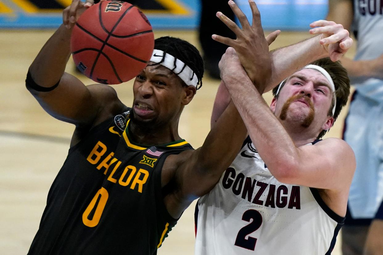 FILE -Baylor forward Flo Thamba (0) fights for a rebound with Gonzaga forward Drew Timme (2) during the first half of the championship game in the men's Final Four NCAA college basketball tournament, Monday, April 5, 2021, at Lucas Oil Stadium in Indianapolis.