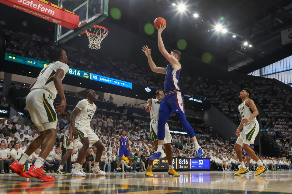 WACO, TX - MARCH 02: Kansas Jayhawks center Hunter Dickinson (1) takes a shot over Baylor Bears forward Josh Ojianwuna (15) and Baylor Bears guard Jayden Nunn (2) during the Big 12 college basketball game between Baylor Bears and Kansas Jayhawks on March 2, 2024, at Foster Pavilion in Waco, TX. (Photo by David Buono/Icon Sportswire via Getty Images)