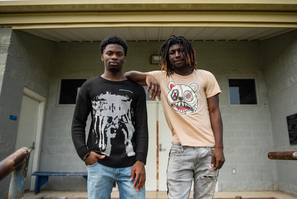 Junior student athletes Arbon Bryant, 17, and Kentrell McElroy, 18, pose in front of the fieldhouse where they lift weights and listen to Coach Watson's speeches at Wingfield High School in Jackson on Wednesday, May 8, 2024. "We have fun here," McElroy said. "We love it."