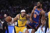 Indiana Pacers' Andrew Nembhard (2) drives past New York Knicks' Alec Burks (18) during the first half of Game 5 in an NBA basketball second-round playoff series, Tuesday, May 14, 2024, in New York. (AP Photo/Frank Franklin II)