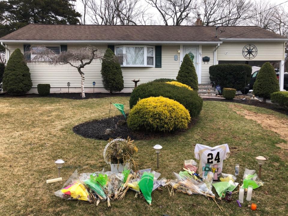 Flowers, candles and a Roxbury football jersey were left outside the Sucasunna home where police say Kellie and Anthony Ventricelli died.