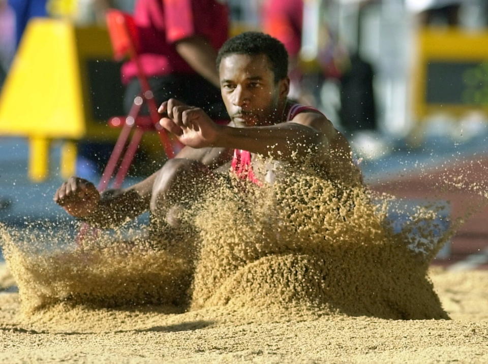 Cuba's Ivan Pedroso lands in the sand during the men's long jump qualification round at the World Athletics Championships in Seville 26 August 1999. (ELECTRONIC IMAGE) (Photo by Eric Feferberg / AFP) (Photo by ERIC FEFERBERG/AFP via Getty Images)