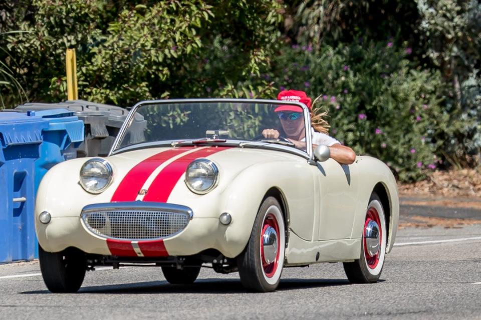 Caitlyn Jenner wears a red “Make America Great Again” (MAGA) while cruising her classic car in Malibu, Calif., on Aug. 3, 2017. (Photo: MEGA)