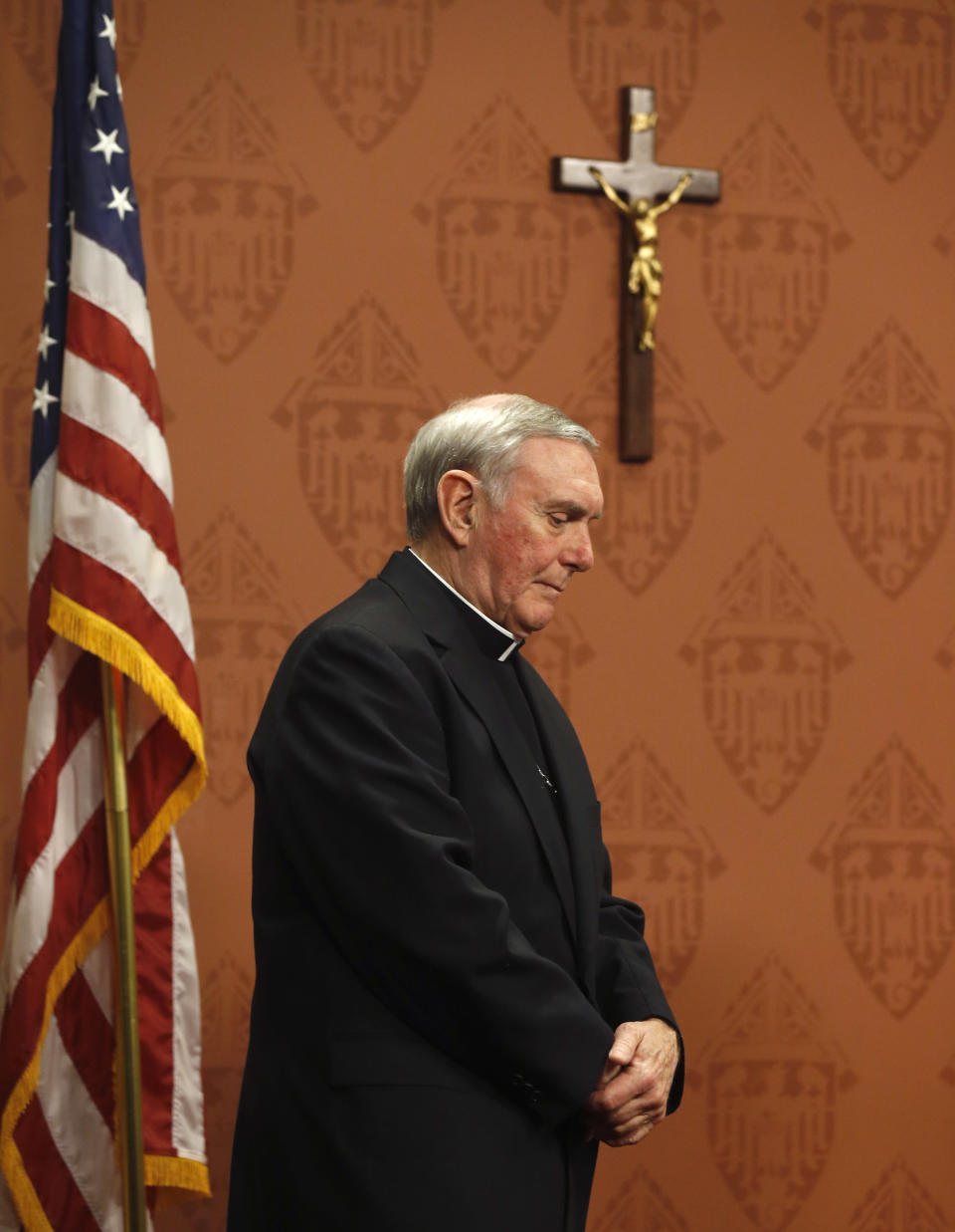 Bishop Francis Kane, Vicar General of the Archdiocese of Chicago, walks to the microphone to respond to a question about the release of 6,000 pages of documents detailing what it knew about decades of clergy sex abuse allegations and how it handled them during a news conference Wednesday, Jan. 15, 2014, in Chicago. (AP Photo/Charles Rex Arbogast)