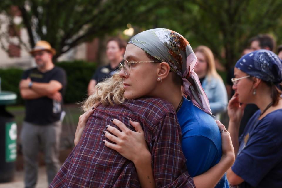 A Purdue University student consoles a friend at a vigil for Sara Brown on Tuesday, Aug. 29 2023, at Purdue University in West Lafayette, Ind. Brown, a Purdue graduate student, was killed Aug. 24, 2023, in a vehicle accident.