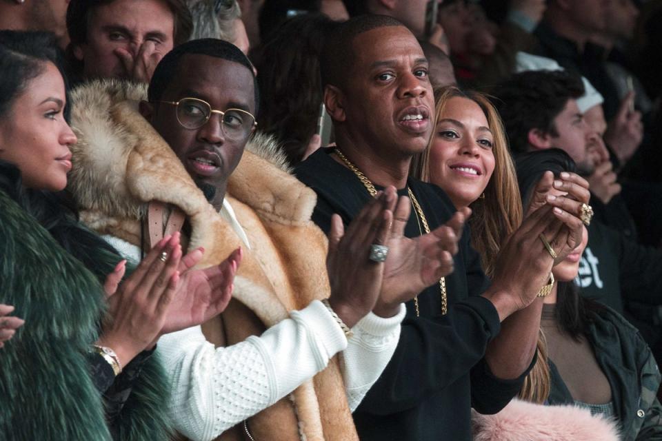 Impressed: Sean Combs, Jay Z, and Beyonce look on proudly from the FROW (Picture: REUTERS/Lucas Jackson) (REUTERS/Lucas Jackson )