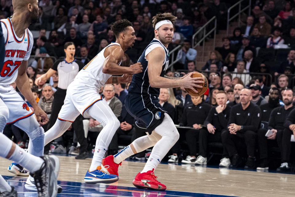 Dallas Mavericks guard Luka Doncic, right, is defended by New York Knicks guard Charlie Brown Jr., center left, during the first half of an NBA basketball game in New York, Thursday, Feb. 8, 2024. (AP Photo/Peter K. Afriyie)