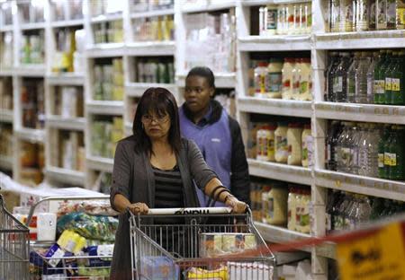 A shopper pushes a trolley of groceries at the Makro branch of South African retailer Massmart in Johannesburg May 31, 2011. REUTERS/Siphiwe Sibeko