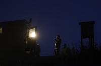 In this picture taken on Thursday, Nov. 15, 2018, fishermen prepare for the traditional fish haul of the Krcin pond near the village of Mazelov, Czech Republic. Czechs will have to pay more for their traditional Christmas delicacy this year after a serious drought devastated the carp population this year. (AP Photo/Petr David Josek)