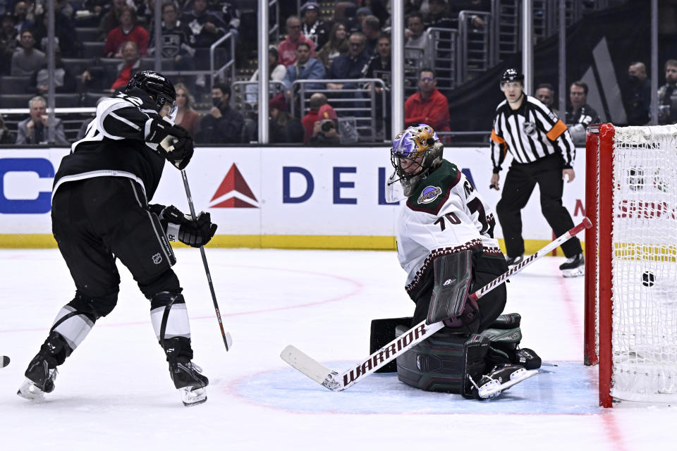 Los Angeles Kings left wing Trevor Moore, left, scores against Arizona Coyotes goaltender Karel Vejmelka during the second period of an NHL hockey game in Los Angeles, Thursday, Dec. 1, 2022. (AP Photo/Alex Gallardo)