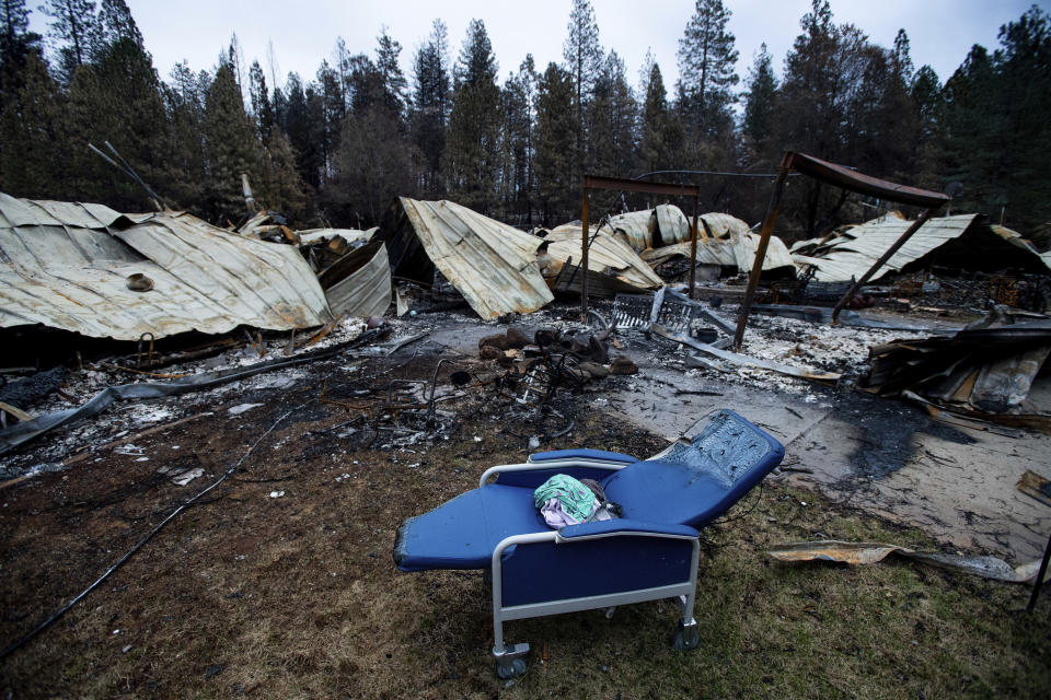 A chair rests outside Cypress Meadows Post-Acute, a nursing home leveled by the Camp Fire, on Tuesday, Dec. 4, 2018, in Paradise, Calif. (AP Photo/Noah Berger)