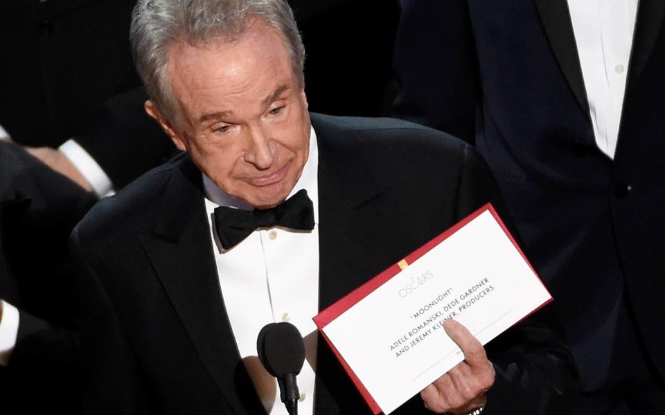 Presenter Warren Beatty holds up an envelope revealing