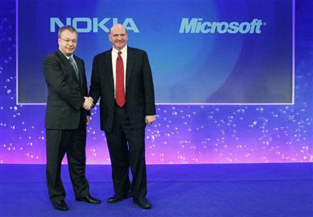 Nokia chief executive Stephen Elop (L) welcomes Microsoft chief executive Steve Ballmer with a handshake at a Nokia event in London in this February 11, 2011 file photograph. REUTERS/Luke MacGregor/Files