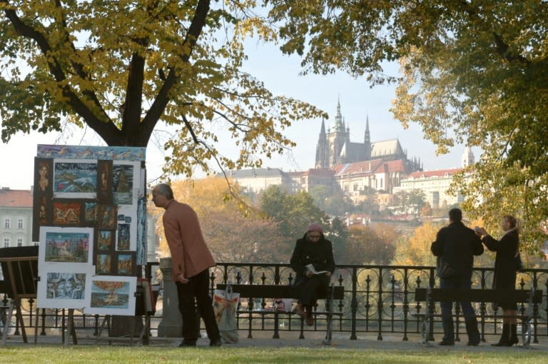 People flock to the Vltava river in downtown Prague