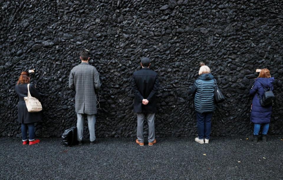 People take part in a performance by artist Marina Abramovic next to her artwork ‘Crystal Wall of Crying’ at Babyn Yar (Reuters)