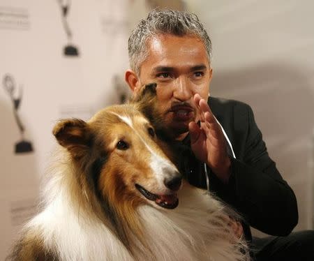Dog trainer Cesar Millan poses with Lassie at 2008 Primetime Creative Arts Awards in Los Angeles September 13, 2008. REUTERS/Mario Anzuoni
