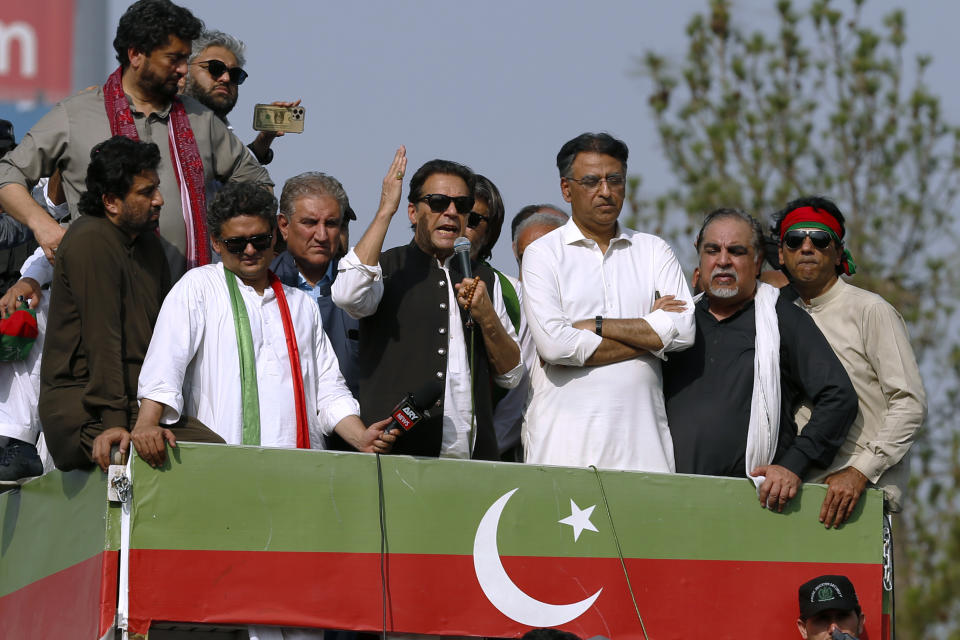 Supporters of Pakistan’s defiant former Prime Minister Imran Khan, center, addresses during an anti-government rally in Islamabad, Pakistan, Thursday, May 26, 2022. Khan early Thursday warned Pakistan's government to set new elections in the next six days or he will again march on the capital along with 3 million people. (AP Photo/Anjum Naveed)