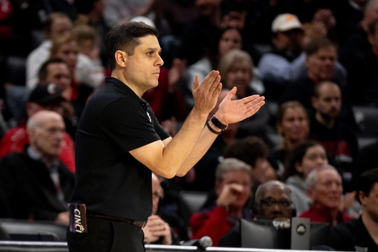 Cincinnati Bearcats head coach Wes Miller claps in the second half of the NCAA basketball game between Cincinnati Bearcats and Oklahoma State Cowboys at Fifth Third Arena in Cincinnati on Wednesday, Feb. 21, 2024.