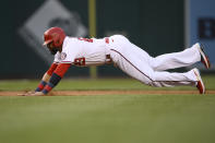 Washington Nationals' Nelson Cruz slides towards third on a single by Josh Bell during the first inning of a baseball game against the Los Angeles Dodgers, Tuesday, May 24, 2022, in Washington. Cruz scored on the play. (AP Photo/Nick Wass)