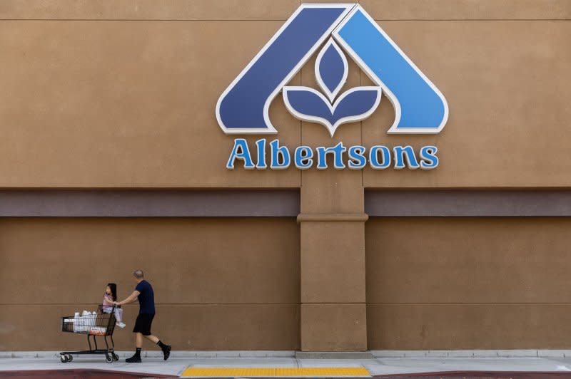 A customer leaves an Albertsons store in Alhambra, east of Los Angeles, in September. The Federal Trade Commission is suing to stop the proposed $24.6 billion acquisition of Albertson's Companies by The Kroger Company, according to court documents filed Monday. File Photo by Laurent Etienne/EPA-EFE