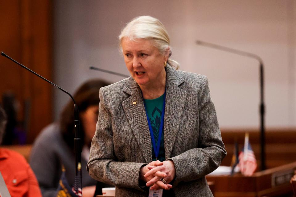 Sen. Deb Patterson, D-Salem, talks with colleagues Tuesday during a Senate floor session. She was among the senators who supported the $200 million housing and homelessness proposal.