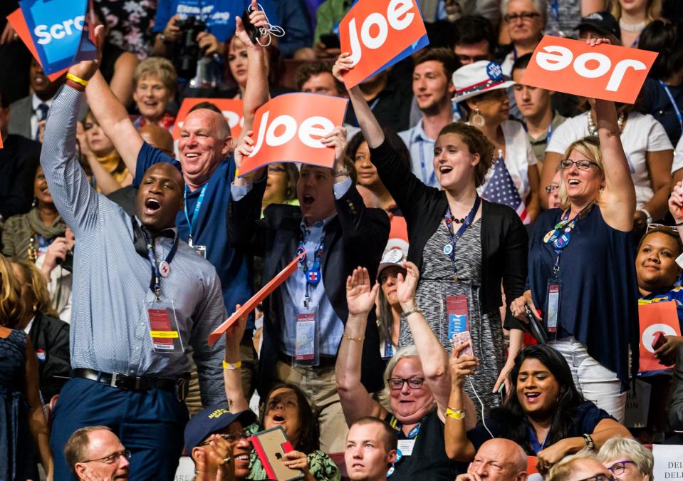 Members of the Delaware delegation cheer wave signs for Joe Biden as he takes the stage during the third day of the Democratic National Convention at the Wells Fargo Center in Philadelphia on July 27, 2016.