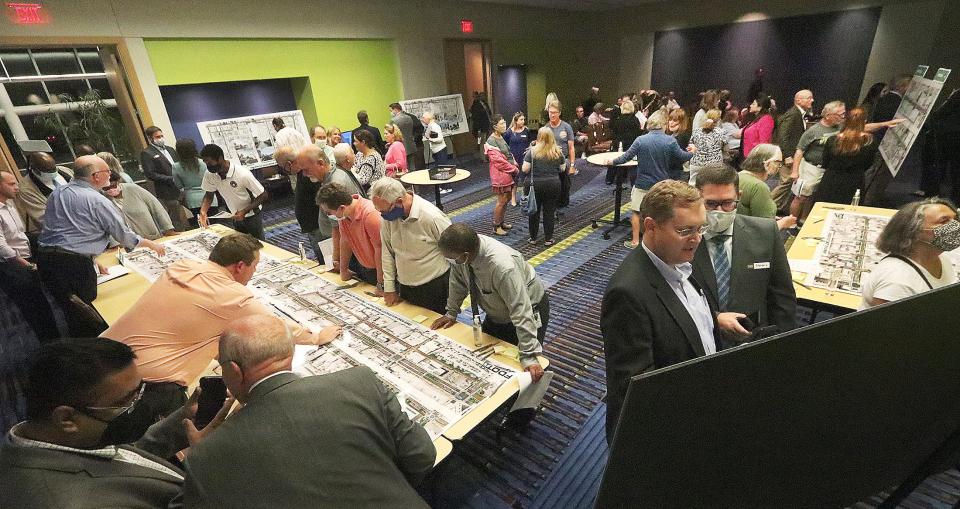 People pore over maps of beachside roadways, Wednesday night November 10 2021 during a public meeting at the Ocen Center on FDOT's roadway projects in Daytona Beach.