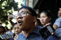 Detained Reuters journalist Wa Lone talks to media while is escorted by police after a court hearing in Yangon, Myanmar April 11, 2018. REUTERS/Ann Wang