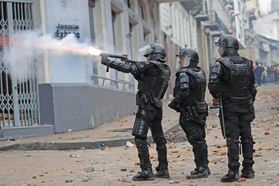 Police fire tear gas at people protesting the president in Quito, Ecuador, Thursday, Oct. 3, 2019. Ecuador's president has declared a state of emergency to confront street protests and a nationwide transport strike over his decision to end government fuel subsidies and relax labor protections. (AP Photo/Dolores Ochoa)