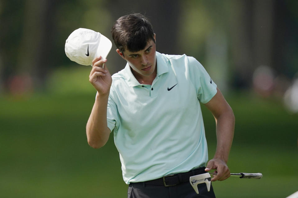 Davis Thompson acknowledges the crowd after finishing his round on the ninth green during the first round of the Rocket Mortgage Classic golf tournament, Thursday, July 1, 2021, at the Detroit Golf Club in Detroit. (AP Photo/Carlos Osorio)