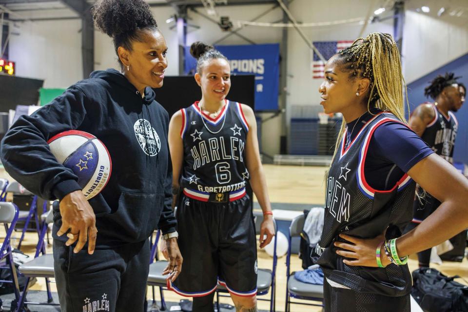 Two-time Olympian and first-ever female Globetrotter Lynette Woodard, who returned to the organization as a special advisor, talking to two current Globetrotters
