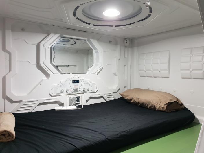 A twin bed inside a sleeper pod
